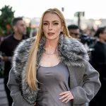 Линдси Лохан в серебристом топе без бретелек удивила поклонников неожиданным появлением на показе "Сумасшедшей пятницы" в Нью-Йорке